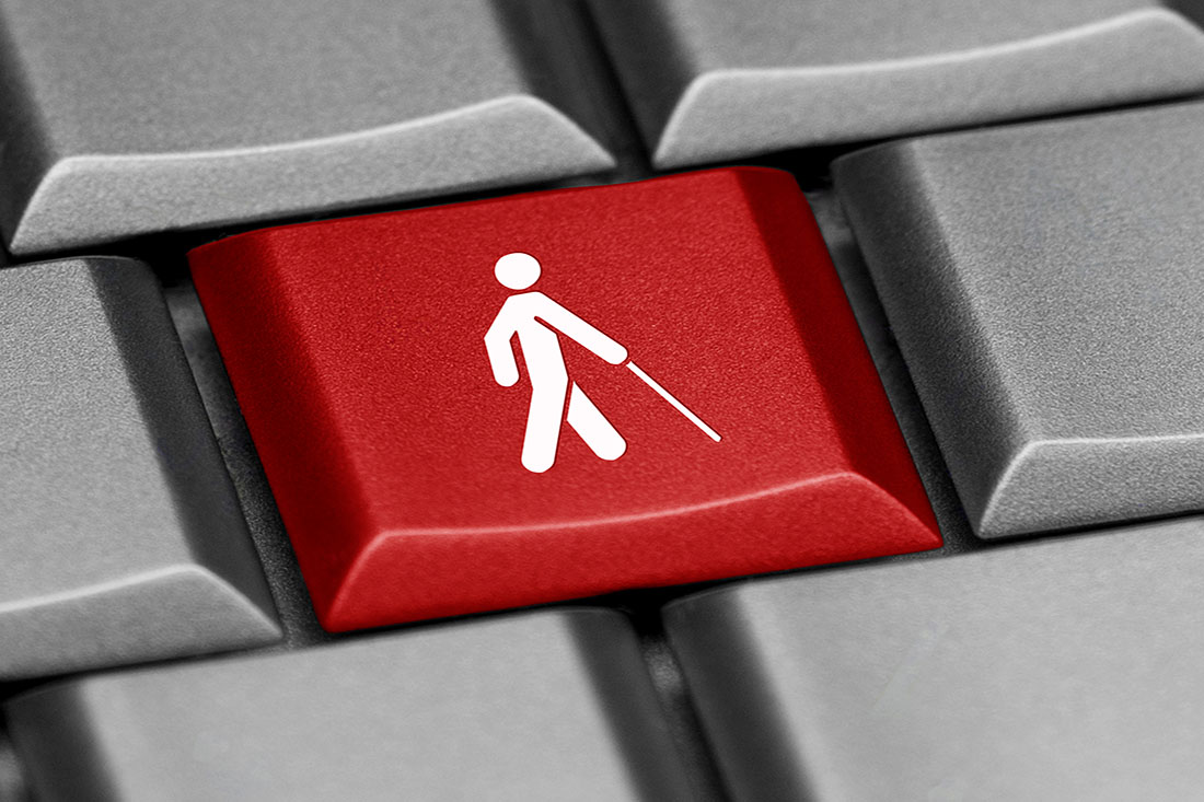 Computer keyboard, one key of which has an icon of an elderly person with a walking stick.